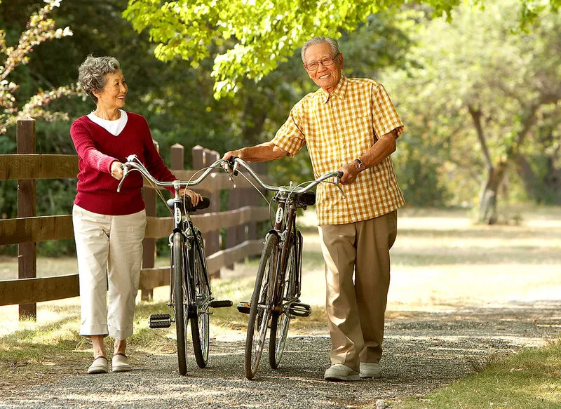 An active older couple enjoying a bike ride outdoors