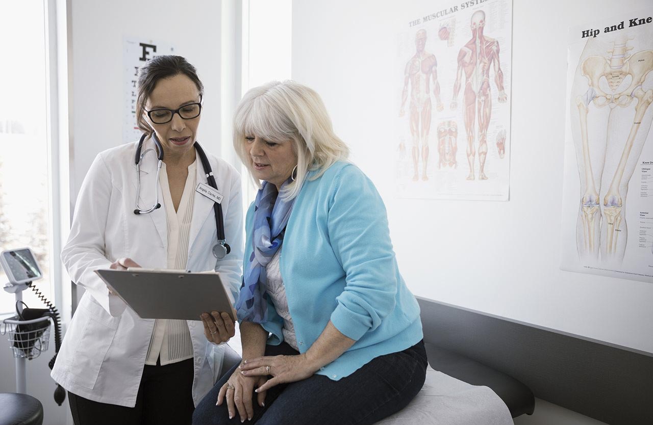 A clinician reviewing information with an older woman
